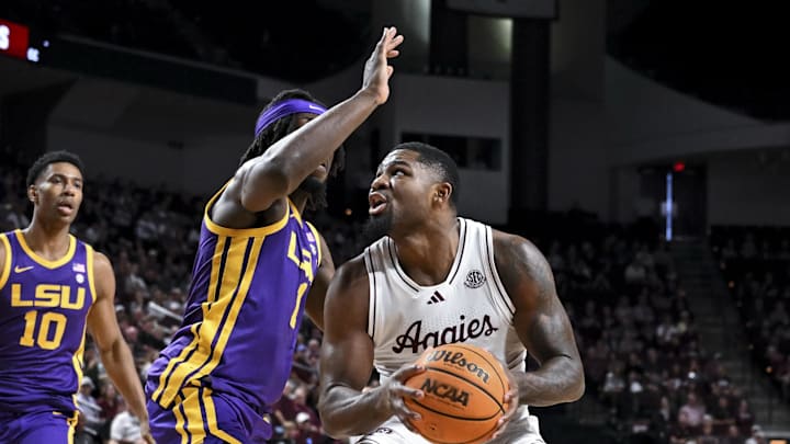 Texas A&M Aggies forward Rashaun Agee (12) goes to the basket against Louisiana State Tigers center Michael Nwoko (1) at Reed Arena. Mandatory Credit: Maria Lysaker-Imagn Images 
