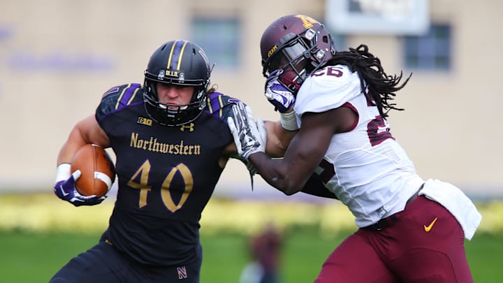 Oct 3, 2015; Evanston, IL, USA; Northwestern Wildcats fullback Dan Vitale (40) stiff arms Minnesota Golden Gophers linebacker De'Vondre Campbell (26) during the first quarter at Ryan Field. Mandatory Credit: Jerry Lai-Imagn Images Oct 3, 2015; Evanston, IL, USA; Northwestern Wildcats fullback Dan Vitale (40) stiff arms Minnesota Golden Gophers linebacker De'Vondre Campbell (26) during the first quarter at Ryan Field. Mandatory Credit: Jerry Lai-Imagn Images