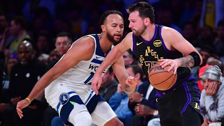 Mar 10, 2026; Los Angeles, California, USA;  Los Angeles Lakers guard Luka Doncic (77) moves the ball against Minnesota Timberwolves forward Kyle Anderson (12) during the second half at Crypto.com Arena. Mandatory Credit: Gary A. Vasquez-Imagn Images
