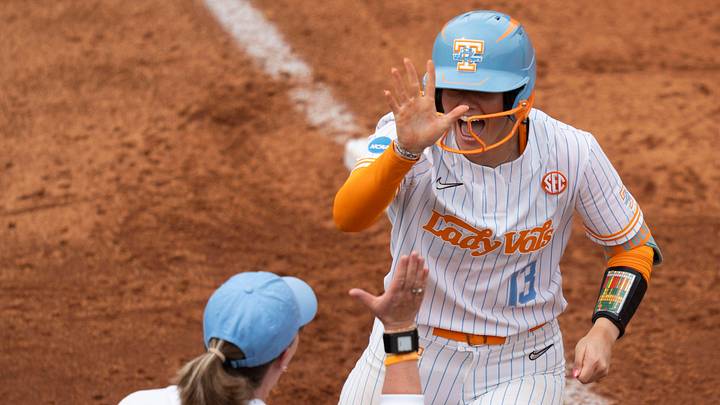 Tennessee's Emma Clarke (13) and Tennessee softball coach Karen Weekly celebrate Clarke’s home run against Virginia in the NCAA college softball regional on May 16, 2026, in Knoxville, Tennessee. Tennessee's Emma Clarke (13) and Tennessee softball coach Karen Weekly celebrate Clarke’s home run against Virginia in the NCAA college softball regional on May 16, 2026, in Knoxville, Tennessee.