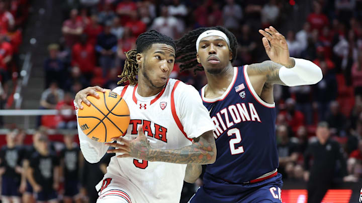 Feb 8, 2024; Salt Lake City, Utah, USA; Utah Utes guard Deivon Smith (5) goes to the basket against Arizona Wildcats guard Caleb Love (2) during the second half at Jon M. Huntsman Center. Mandatory Credit: Rob Gray-Imagn Images