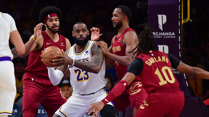 Apr 6, 2024; Los Angeles, California, USA;  Los Angeles Lakers forward LeBron James (23) controls the ball against Cleveland Cavaliers center Jarrett Allen (31) forward Evan Mobley (4) and guard Darius Garland (10) during the first half at Crypto.com Arena. Mandatory Credit: Gary A. Vasquez-Imagn Images