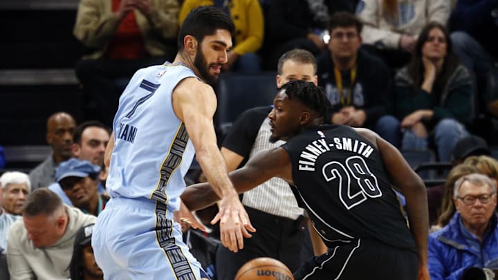 Dec 13, 2024; Memphis, Tennessee, USA; Memphis Grizzlies forward Santi Aldama (7) dribbles around Brooklyn Nets forward Dorian Finney-Smith (28) during the second quarter at FedExForum. Mandatory Credit: Petre Thomas-Imagn Images