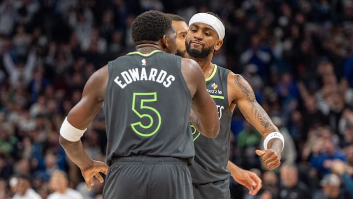 Minnesota Timberwolves guards Anthony Edwards (5) and Nickeil Alexander-Walker celebrate a win over the Denver Nuggets as the final buzzer sounds at Target Center in Minneapolis on Nov. 1, 2024. 