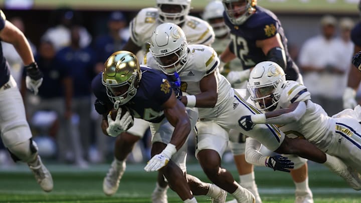 Oct 19, 2024; Atlanta, Georgia, USA; Notre Dame Fighting Irish running back Jadarian Price (24) is tackled by Georgia Tech Yellow Jackets defensive back Taye Seymore (7) in the third quarter at Mercedes-Benz Stadium. Mandatory Credit: Brett Davis-Imagn Images Oct 19, 2024; Atlanta, Georgia, USA; Notre Dame Fighting Irish running back Jadarian Price (24) is tackled by Georgia Tech Yellow Jackets defensive back Taye Seymore (7) in the third quarter at Mercedes-Benz Stadium. Mandatory Credit: Brett Davis-Imagn Images