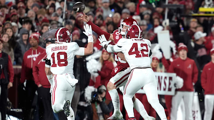 Oklahoma Sooners quarterback John Mateer (10) is pressured by Alabama Crimson Tide linebacker Yhonzae Pierre (42) and defensive back Bray Hubbard (18) as he throws a pass during a first-round College Football Playoff game between the University of Oklahoma Sooners (OU) and the Alabama Crimson Tide at Gaylord Family – Oklahoma Memorial Stadium in Norman, Okla., Friday, Dec. 19, 2025. Alabama won 34-24.