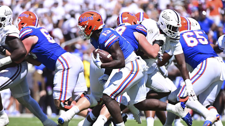 Sep 21, 2024; Starkville, Mississippi, USA; Florida Gators running back Jadan Baugh (13) runs the ball against the Mississippi State Bulldogs during the fourth quarter at Davis Wade Stadium at Scott Field. Mandatory Credit: Matt Bush-Imagn Images