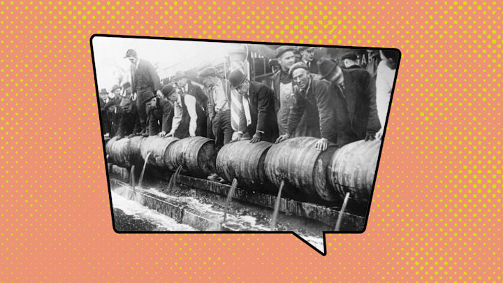 Officials emptying barrels of beer during Prohibition.