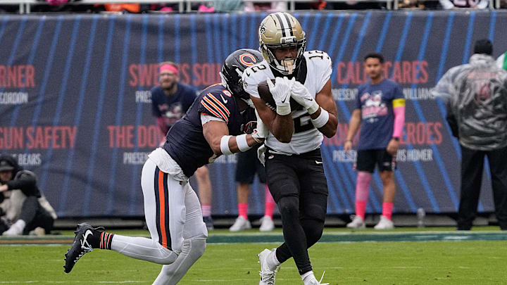 Oct 19, 2025; Chicago, Illinois, USA; New Orleans Saints wide receiver Chris Olave (12) runs with the ball after making a catch against Chicago Bears cornerback Kyler Gordon (6) during the first half at Soldier Field. Mandatory Credit: David Banks-Imagn Images Oct 19, 2025; Chicago, Illinois, USA; New Orleans Saints wide receiver Chris Olave (12) runs with the ball after making a catch against Chicago Bears cornerback Kyler Gordon (6) during the first half at Soldier Field. Mandatory Credit: David Banks-Imagn Images