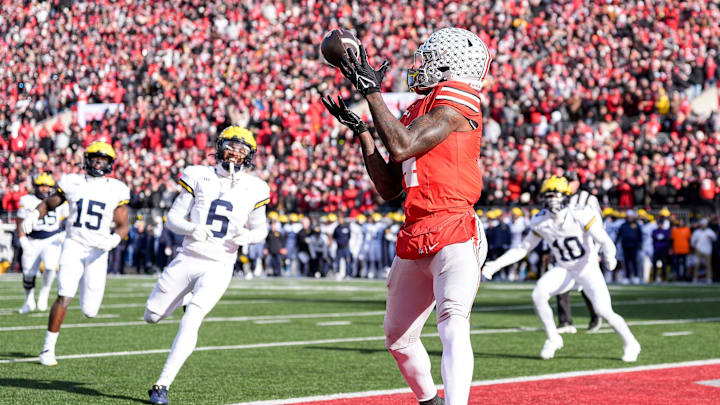 Ohio State wide receiver Jeremiah Smith (4) makes a catch for a touchdown against Michigan during the first half at Ohio Stadium in Columbus, Ohio on Saturday, Nov. 30, 2024.
