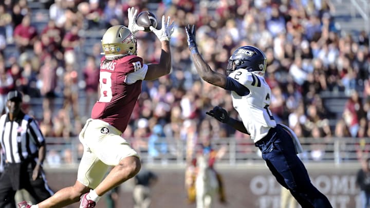 Nov 23, 2024; Tallahassee, Florida, USA; Florida State Seminoles tight end Landen Thomas (18) catches a pass during the second half of the game against Charleston Southern Buccaneers safety Davion Williams (2) at Doak S. Campbell Stadium. Mandatory Credit: Melina Myers-Imagn Images