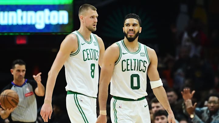 Mar 5, 2024; Cleveland, Ohio, USA; Boston Celtics center Kristaps Porzingis (8) and forward Jayson Tatum (0) react after a play during the second half against the Cleveland Cavaliers at Rocket Mortgage FieldHouse. Mandatory Credit: Ken Blaze-Imagn Images