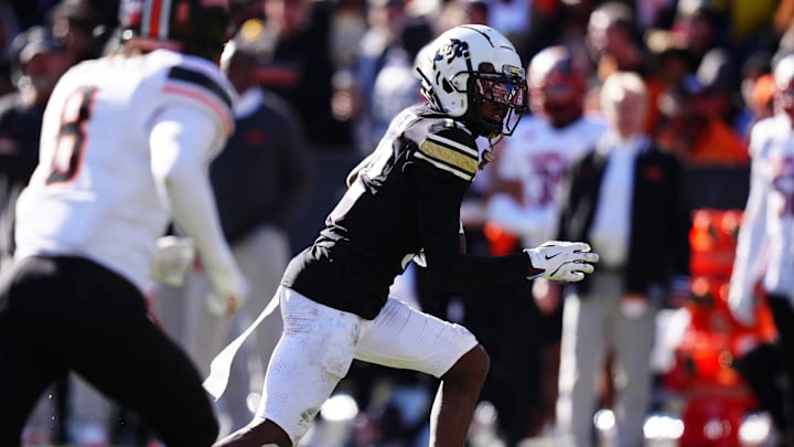 Nov 29, 2024; Boulder, Colorado, USA; Colorado Buffaloes wide receiver Travis Hunter (12) carries the ball in the third quarter against the Oklahoma State Cowboys at Folsom Field. Mandatory Credit: Ron Chenoy-Imagn Images