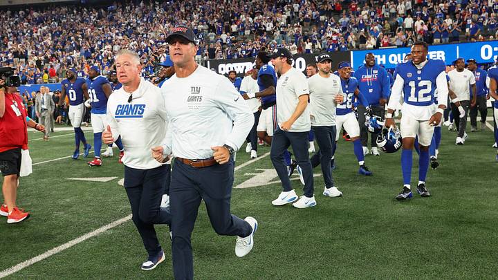 Sep 13, 2026; East Rutherford, New Jersey, USA; New York Giants head coach John Harbaugh runs onto the field after defeating the Dallas Cowboys in the game at MetLife Stadium. Sep 13, 2026; East Rutherford, New Jersey, USA; New York Giants head coach John Harbaugh runs onto the field after defeating the Dallas Cowboys in the game at MetLife Stadium.