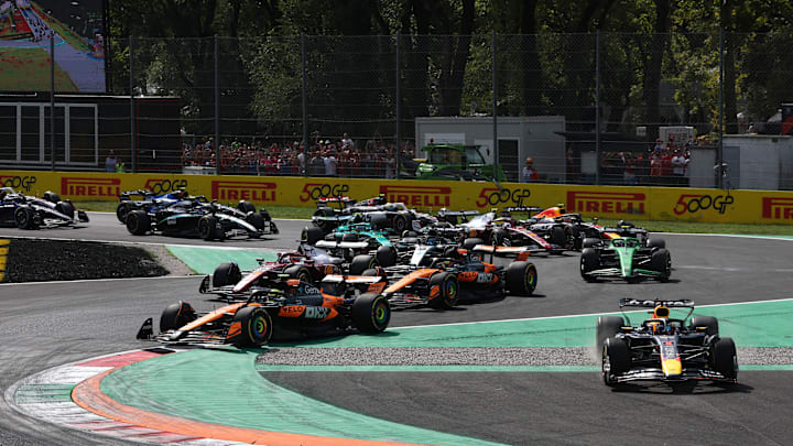 Max Verstappen, Red Bull, hops across the Rettifilo at the start of the 2025 Formula 1 Italian Grand Prix after battling with McLaren's Lando Norris. Autodromo Nazionale Monza, Monza.