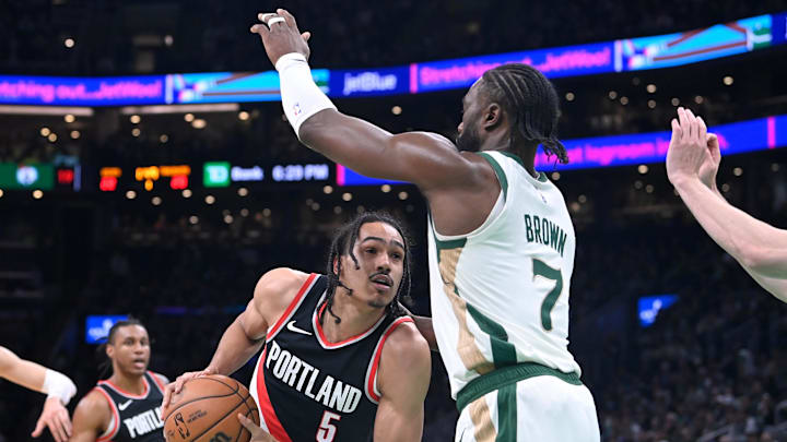 Apr 7, 2024; Boston, Massachusetts, USA; Portland Trail Blazers guard Dalano Banton (5) drives the ball  against Boston Celtics guard Jaylen Brown (7) during the first half at TD Garden. Mandatory Credit: Eric Canha-Imagn Images