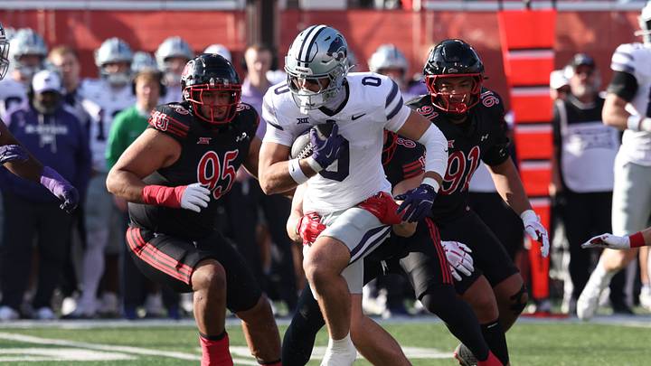 Nov 22, 2025; Salt Lake City, Utah, USA; Kansas State Wildcats tight end Linkon Cure (0) runs after a catch as Utah Utes defensive tackle Aliki Vimahi (95) and defensive tackle Jonah Lea'Ea (91) defend during the first quarter at Rice-Eccles Stadium. Mandatory Credit: Rob Gray-Imagn Images Nov 22, 2025; Salt Lake City, Utah, USA; Kansas State Wildcats tight end Linkon Cure (0) runs after a catch as Utah Utes defensive tackle Aliki Vimahi (95) and defensive tackle Jonah Lea'Ea (91) defend during the first quarter at Rice-Eccles Stadium. Mandatory Credit: Rob Gray-Imagn Images