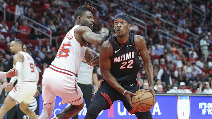 Apr 5, 2024; Houston, Texas, USA; Miami Heat forward Jimmy Butler (22) drives towards the basket as Houston Rockets forward Reggie Bullock Jr. (25) defends during the third quarter at Toyota Center. Mandatory Credit: Troy Taormina-Imagn Images