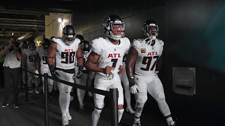 Sep 16, 2024; Philadelphia, Pennsylvania, USA; Atlanta Falcons defensive tackle David Onyemata (90), wide receiver Darnell Mooney (1) and defensive end Grady Jarrett (97) lead the team onto the field against the Philadelphia Eagles at Lincoln Financial Field. Mandatory Credit: Eric Hartline-Imagn Images