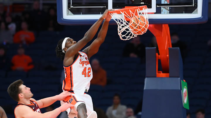 Jan 21, 2026; Syracuse, New York, USA; Syracuse Orange forward William Kyle III (42) dunks against Virginia Tech Hokies center Christian Gurdak (32) during the first half at the JMA Wireless Dome. Mandatory Credit: Rich Barnes-Imagn Images
