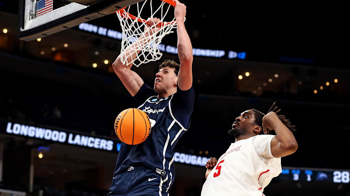 Mar 22, 2024; Memphis, TN, USA; Longwood Lancers center Szymon Zapala (12) dunks the ball against Houston Cougars forward Ja'Vier Francis (5) during the second half in the first round of the 2024 NCAA Tournament at FedExForum. Mandatory Credit: Petre Thomas-USA TODAY Sports Mar 22, 2024; Memphis, TN, USA; Longwood Lancers center Szymon Zapala (12) dunks the ball against Houston Cougars forward Ja'Vier Francis (5) during the second half in the first round of the 2024 NCAA Tournament at FedExForum. Mandatory Credit: Petre Thomas-USA TODAY Sports