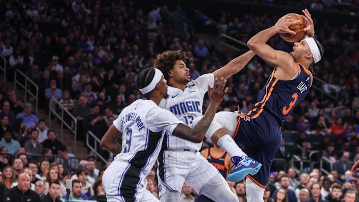New York Knicks guard Josh Hart looks to shoot over Orlando Magic guards Jett Howard and Kentavious Caldwell-Pope