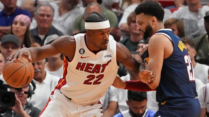 Miami Heat forward Jimmy Butler (22) dribbles the ball against Denver Nuggets guard Jamal Murray (27) during the first quarter in game four of the 2023 NBA Finals at Kaseya Center. Mandatory Credit: Kyle Terada-Imagn Images