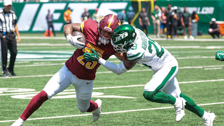 Aug 10, 2024; East Rutherford, New Jersey, USA; Washington Commanders running back Chris Rodriguez Jr. (23) carries the ball as New York Jets cornerback Jarrick Bernard-Converse (29) tackles during the first half at MetLife Stadium. Mandatory Credit: Vincent Carchietta-Imagn Images Aug 10, 2024; East Rutherford, New Jersey, USA; Washington Commanders running back Chris Rodriguez Jr. (23) carries the ball as New York Jets cornerback Jarrick Bernard-Converse (29) tackles during the first half at MetLife Stadium. Mandatory Credit: Vincent Carchietta-Imagn Images