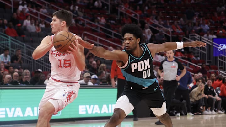Mar 6, 2026; Houston, Texas, USA;  Houston Rockets guard Reed Sheppard (15) dribbles against Portland Trail Blazers guard Scoot Henderson (00) in the first half at Toyota Center. Mandatory Credit: Thomas Shea-Imagn Images