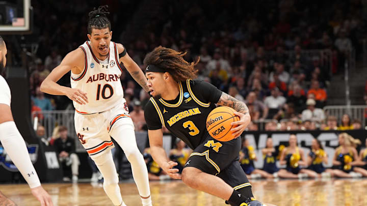 Mar 28, 2025; Atlanta, GA, USA; Michigan Wolverines guard Tre Donaldson (3) drives against Auburn Tigers guard Chad Baker-Mazara (10) in the first half of a South Regional semifinal of the 2025 NCAA tournament at State Farm Arena. Mandatory Credit: Dale Zanine-Imagn Images
