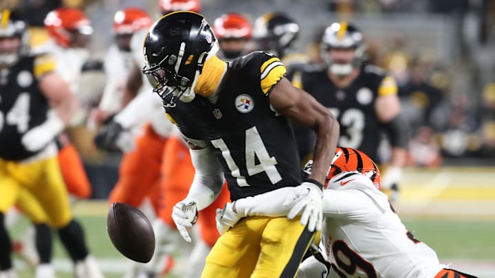 Jan 4, 2025; Pittsburgh, Pennsylvania, USA;  Pittsburgh Steelers wide receiver George Pickens (14) drops a pass as he is defended by Cincinnati Bengals cornerback Cam Taylor-Britt (29) during the fourth quarter at Acrisure Stadium. Mandatory Credit: Charles LeClaire-Imagn Images