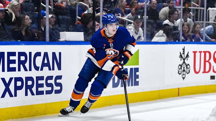 Apr 15, 2025; Elmont, New York, USA; New York Islanders defenseman Noah Dobson (8) skates with the puck during the third period against the Washington Capitals at UBS Arena. Mandatory Credit: John Jones-Imagn Images