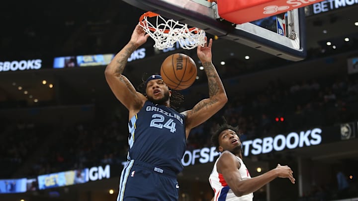 Apr 5, 2024; Memphis, Tennessee, USA; Memphis Grizzlies forward Lamar Stevens (24) dunks over Detroit Pistons center James Wiseman (13) during the first half at FedExForum. Mandatory Credit: Petre Thomas-Imagn Images