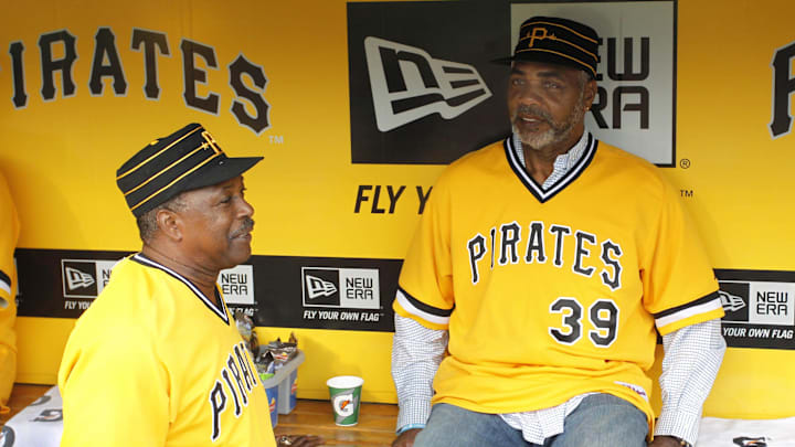 May 21, 2014; Pittsburgh, PA, USA; Pittsburgh Pirates former shortstop Rennie Stennett (left) talks with Pirates former right fielder Dave Parker (39) before the Pirates host the Baltimore Orioles at PNC Park. The Pirates won 9-8. Mandatory Credit: Charles LeClaire-Imagn Images