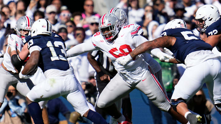 Ohio State Buckeyes defensive tackle Ty Hamilton (58) pursues Penn State Nittany Lions running back Kaytron Allen (13) during the first half of the NCAA football game at Beaver Stadium.