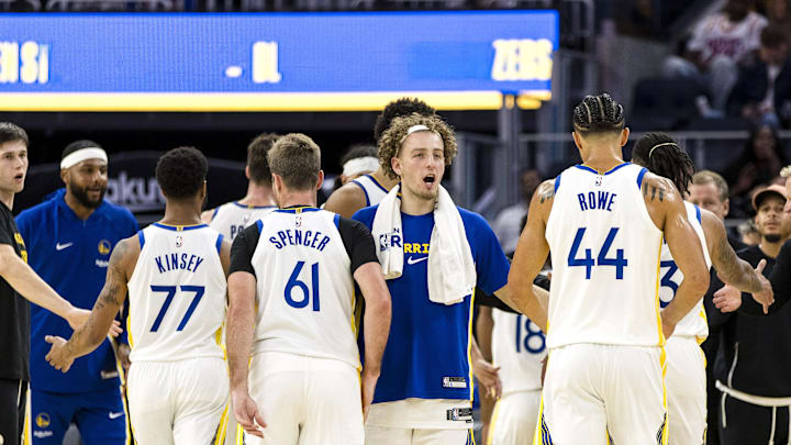 Oct 8, 2025; San Francisco, California, USA; Golden State Warriors guard Brandin Podziemski (2) congratulates forward Jackson Rowe (44), guard Pat Spencer (61), guard Taevion Kinsey (77), and other players during the fourth quarter against the Portland Trail Blazers at Chase Center. Mandatory Credit: John Hefti-Imagn Images Oct 8, 2025; San Francisco, California, USA; Golden State Warriors guard Brandin Podziemski (2) congratulates forward Jackson Rowe (44), guard Pat Spencer (61), guard Taevion Kinsey (77), and other players during the fourth quarter against the Portland Trail Blazers at Chase Center. Mandatory Credit: John Hefti-Imagn Images