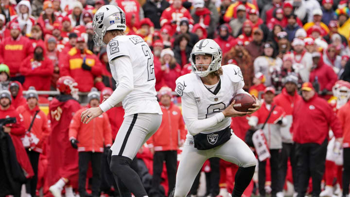 Dec 25, 2023; Kansas City, Missouri, USA; Las Vegas Raiders punter AJ Cole (6) runs the ball as place kicker Daniel Carlson (2) blocks against the Kansas City Chiefs on a fake kick play during the game at GEHA Field at Arrowhead Stadium. Mandatory Credit: Denny Medley-USA TODAY Sports
