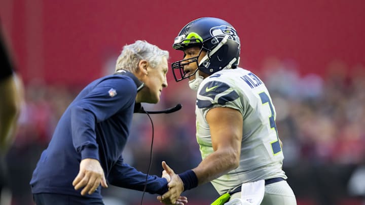 Jan 9, 2022; Glendale, Arizona, USA; Seattle Seahawks quarterback Russell Wilson (3) celebrates a touchdown with head coach Pete Carroll against the Arizona Cardinals in the first half at State Farm Stadium.