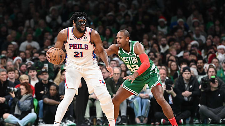 Dec 25, 2024; Boston, Massachusetts, USA; Philadelphia 76ers center Joel Embiid (21) dribbles against Boston Celtics center Al Horford (42) during the second half at TD Garden. Mandatory Credit: Eric Canha-Imagn Images