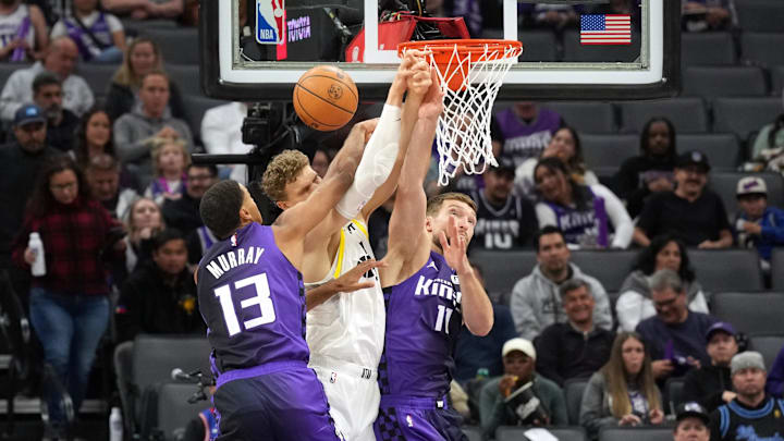 Dec 8, 2024; Sacramento, California, USA; Sacramento Kings forward Domantas Sabonis (right) and forward Keegan Murray (13) knock away a pass intended for Utah Jazz forward Lauri Markkanen (center) during the first quarter at Golden 1 Center. Mandatory Credit: Darren Yamashita-Imagn Images