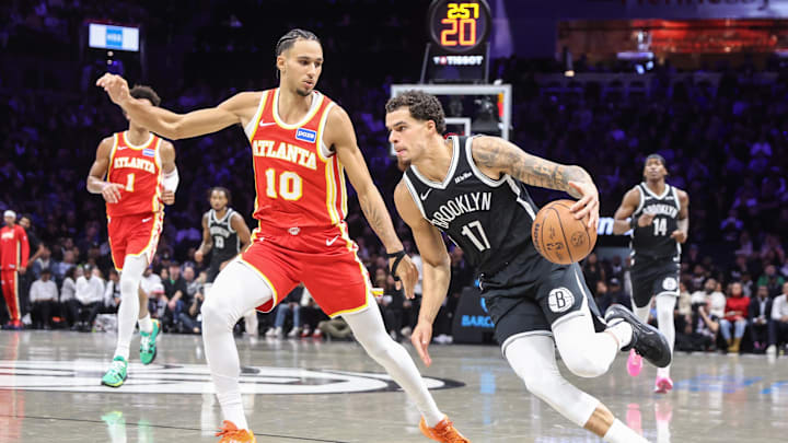 Oct 29, 2025; Brooklyn, New York, USA; Brooklyn Nets forward Michael Porter Jr. (17) looks to drive past Atlanta Hawks forward Zaccharie Risacher (10) in the second quarter at Barclays Center. Mandatory Credit: Wendell Cruz-Imagn Images