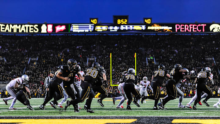 Nov 4, 2017; Iowa City, IA, USA; Iowa Hawkeyes quarterback Nathan Stanley (4) hands the ball off to running back James Butler (20) against the Ohio State Buckeyes during the fourth quarter at Kinnick Stadium. Iowa won 55-24. Mandatory Credit: Jeffrey Becker-Imagn Images Nov 4, 2017; Iowa City, IA, USA; Iowa Hawkeyes quarterback Nathan Stanley (4) hands the ball off to running back James Butler (20) against the Ohio State Buckeyes during the fourth quarter at Kinnick Stadium. Iowa won 55-24. Mandatory Credit: Jeffrey Becker-Imagn Images