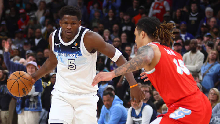Jan 20, 2025; Memphis, Tennessee, USA; Minnesota Timberwolves guard Anthony Edwards (5) dribbles as Memphis Grizzlies forward Brandon Clarke (15) defends during the fourth quarter at FedExForum. Mandatory Credit: Petre Thomas-Imagn Images