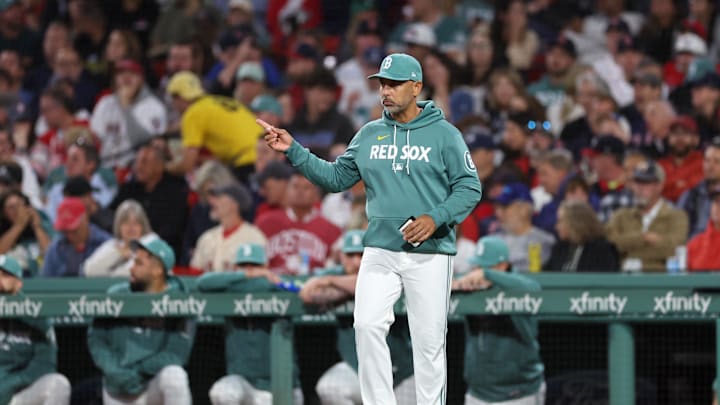 Sep 12, 2025; Boston, Massachusetts, USA; Boston Red Sox manager Alex Cora (13) signals to the bullpen during the sixth inning against the New York Yankees at Fenway Park. Mandatory Credit: Paul Rutherford-Imagn Images