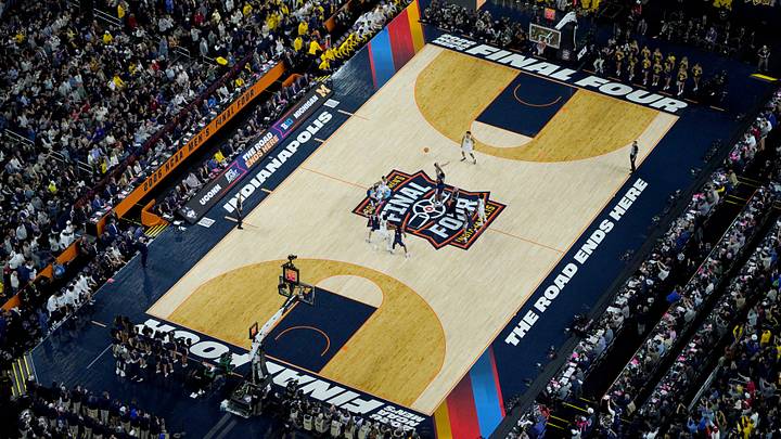 Michigan Wolverines center Aday Mara (15) and UConn Huskies forward Tarris Reed Jr. (5) tip off Monday, April 6, 2026, during the NCAA Men's Basketball Tournament National Championship game at Lucas Oil Stadium in Indianapolis.