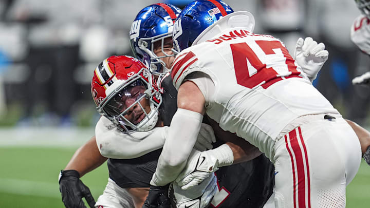 Dec 22, 2024; Atlanta, Georgia, USA; Atlanta Falcons running back Bijan Robinson (7) is tackled by New York Giants linebacker Darius Muasau (53) and linebacker Ty Summers (47) during the second half at Mercedes-Benz Stadium. Dec 22, 2024; Atlanta, Georgia, USA; Atlanta Falcons running back Bijan Robinson (7) is tackled by New York Giants linebacker Darius Muasau (53) and linebacker Ty Summers (47) during the second half at Mercedes-Benz Stadium.