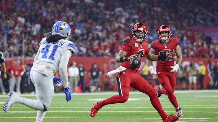 Nov 10, 2024; Houston, Texas, USA; Houston Texans quarterback C.J. Stroud (7) scrambles with the ball as Detroit Lions linebacker James Houston (41) defends during the first quarter at NRG Stadium. Mandatory Credit: Troy Taormina-Imagn Images