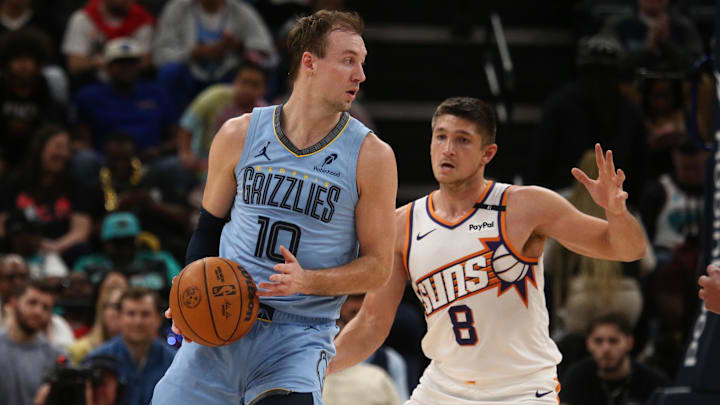 Feb 25, 2025; Memphis, Tennessee, USA; Memphis Grizzlies guard Luke Kennard (10) handles the ball as Phoenix Suns guard Grayson Allen (8) defends during the fourth quarter at FedExForum. Mandatory Credit: Petre Thomas-Imagn Images