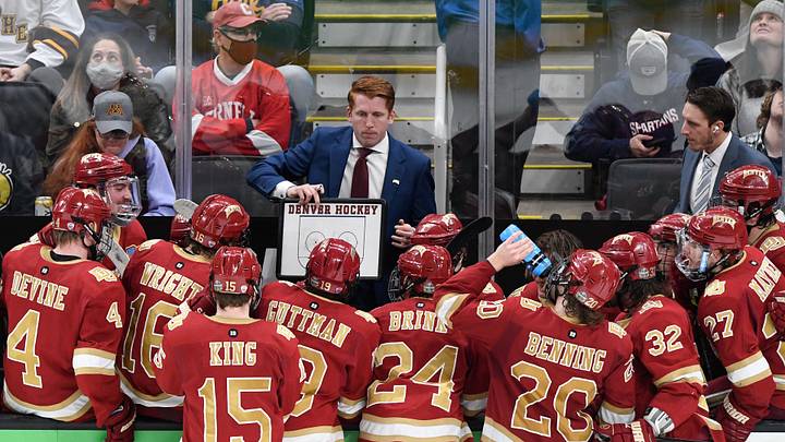 Apr 9, 2022; Boston, MA, USA; Denver Pioneers head coach David Carle talks with his team during a timeout during the third period of the 2022 Frozen Four college ice hockey national championship game against the Minnesota State Mavericks at TD Garden. Mandatory Credit: Brian Fluharty-Imagn Images Apr 9, 2022; Boston, MA, USA; Denver Pioneers head coach David Carle talks with his team during a timeout during the third period of the 2022 Frozen Four college ice hockey national championship game against the Minnesota State Mavericks at TD Garden. Mandatory Credit: Brian Fluharty-Imagn Images