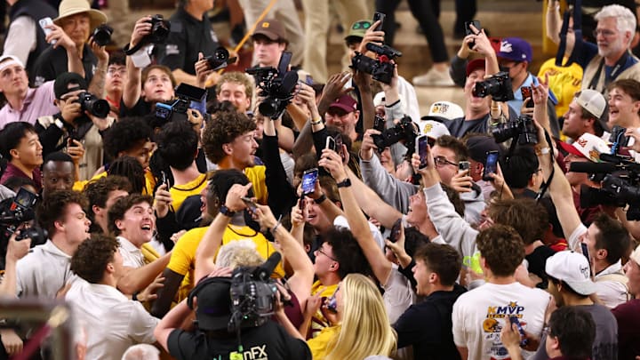 Mar 3, 2026; Tempe, Arizona, USA; Arizona State Sun Devils fans celebrate with players on the court after defeating the Kansas Jayhawks at Desert Financial Arena. Mandatory Credit: Mark J. Rebilas-Imagn Images